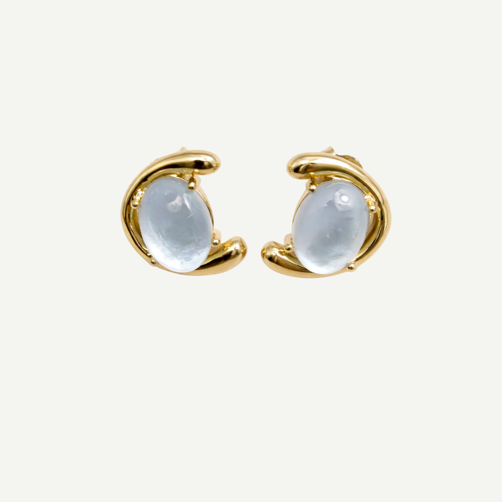 Gold hoop earrings with nacre gemstones on a white background