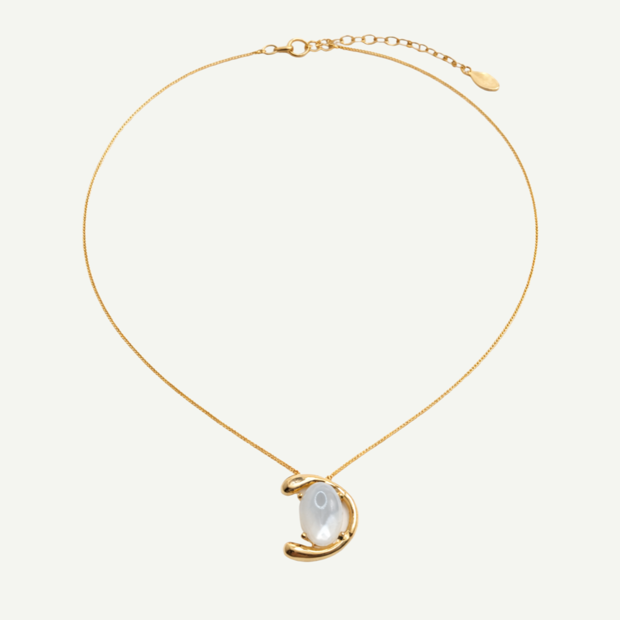 Gold necklace with a half-moon pendant and nacre gemstone on a white background