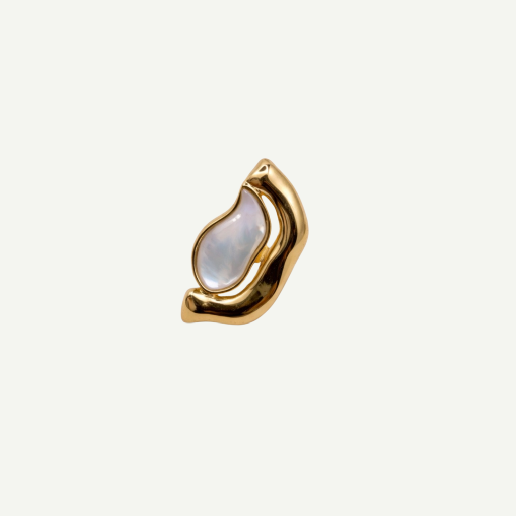 Gold ring with a mother-of-pearl gemstone on a white background