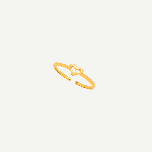 Gold heart-shaped ring on a light gray background
