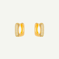 Luz earrings with embedded stones on a light gray background