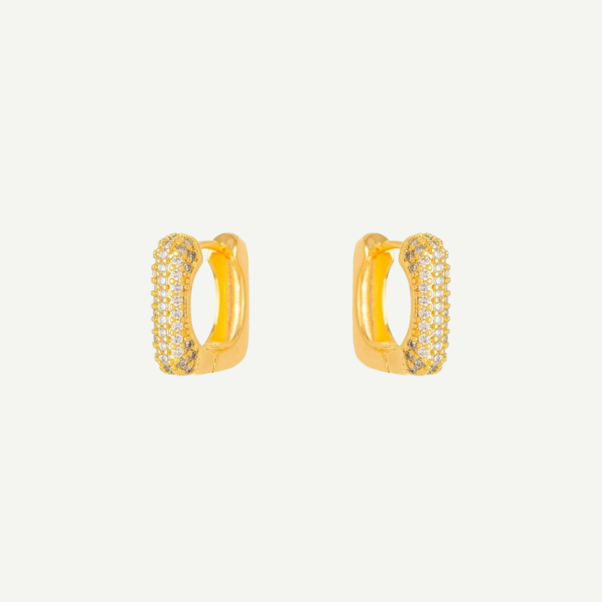 Luz earrings with embedded stones on a light gray background