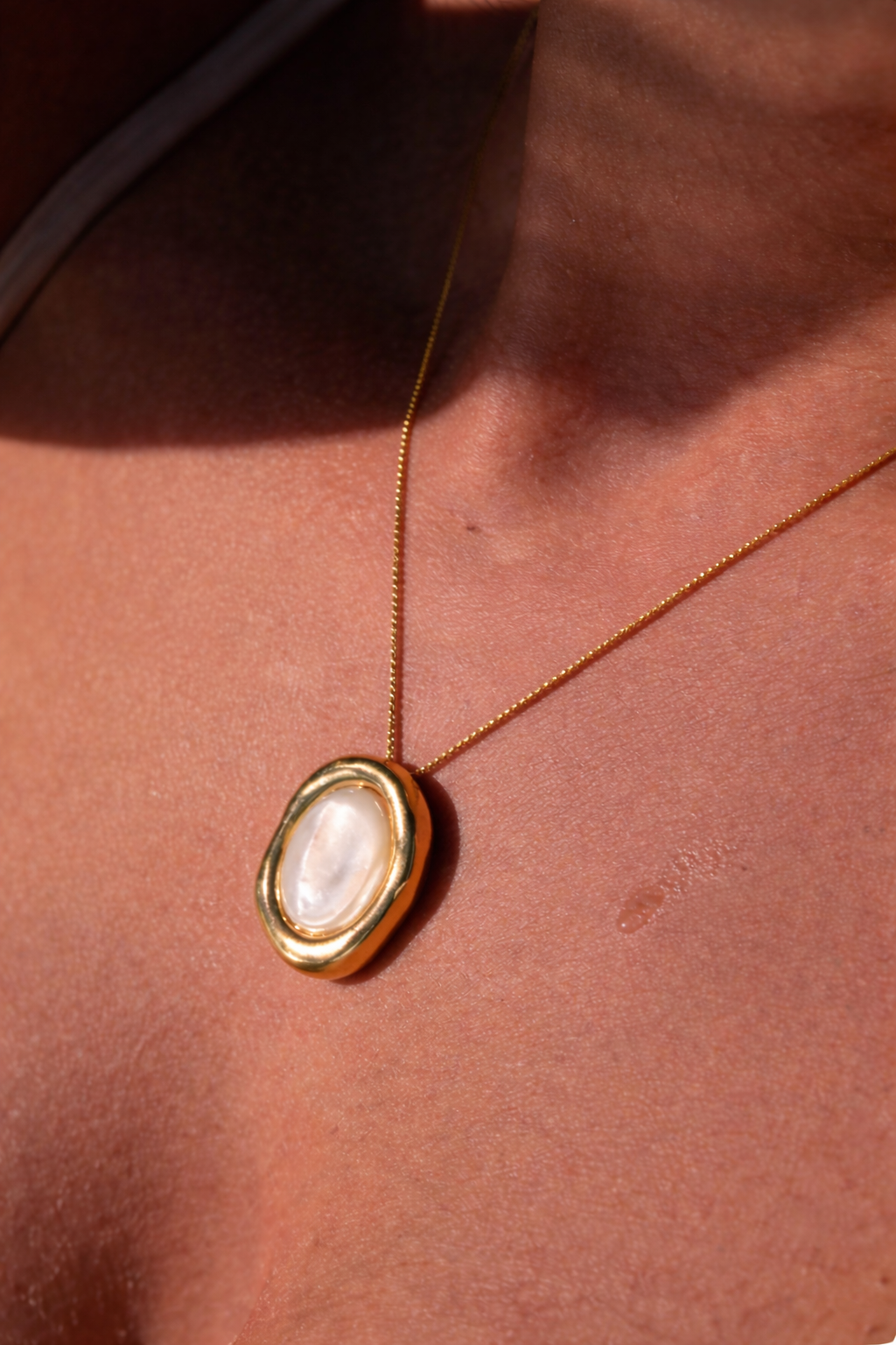 Necklace with a pendant on a person's neck