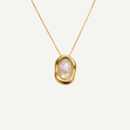 Gold necklace with a nacre pendant on a white background