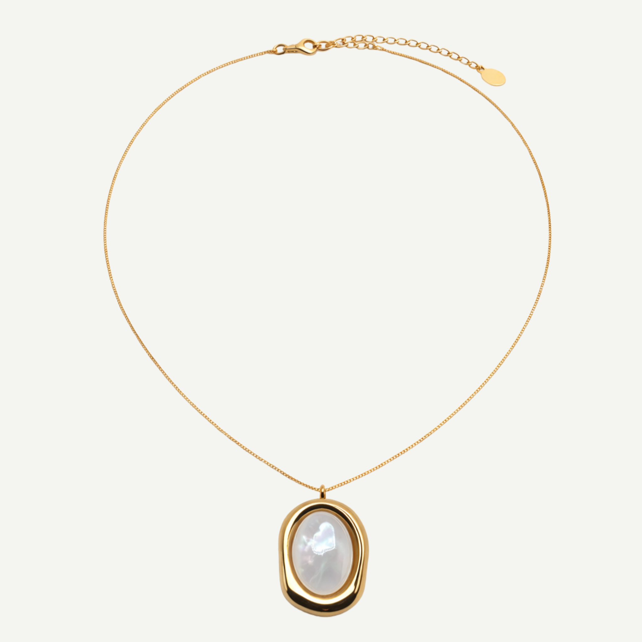 Gold necklace with a nacre pendant on a white background