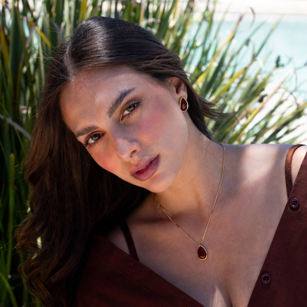 Woman wearing natural agate necklace and earrings