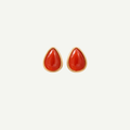 Teardrop-shaped red earrings with gold accents on a white background