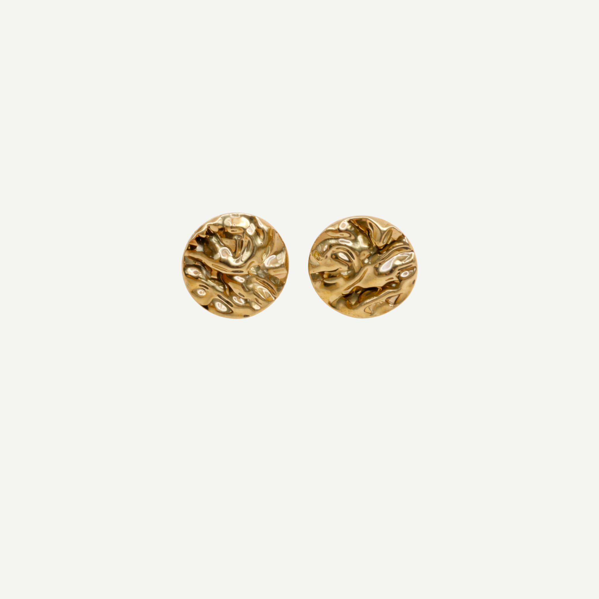 Pair of gold round earrings on a white background