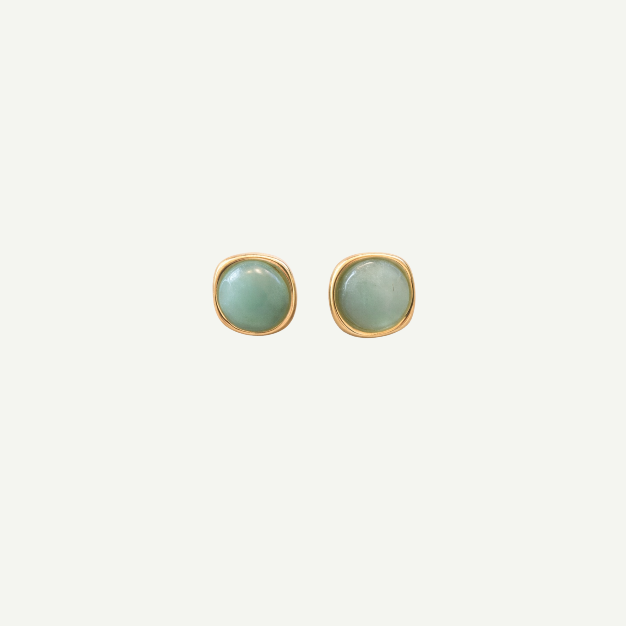 Pair of square earrings with green gemstones on a white background